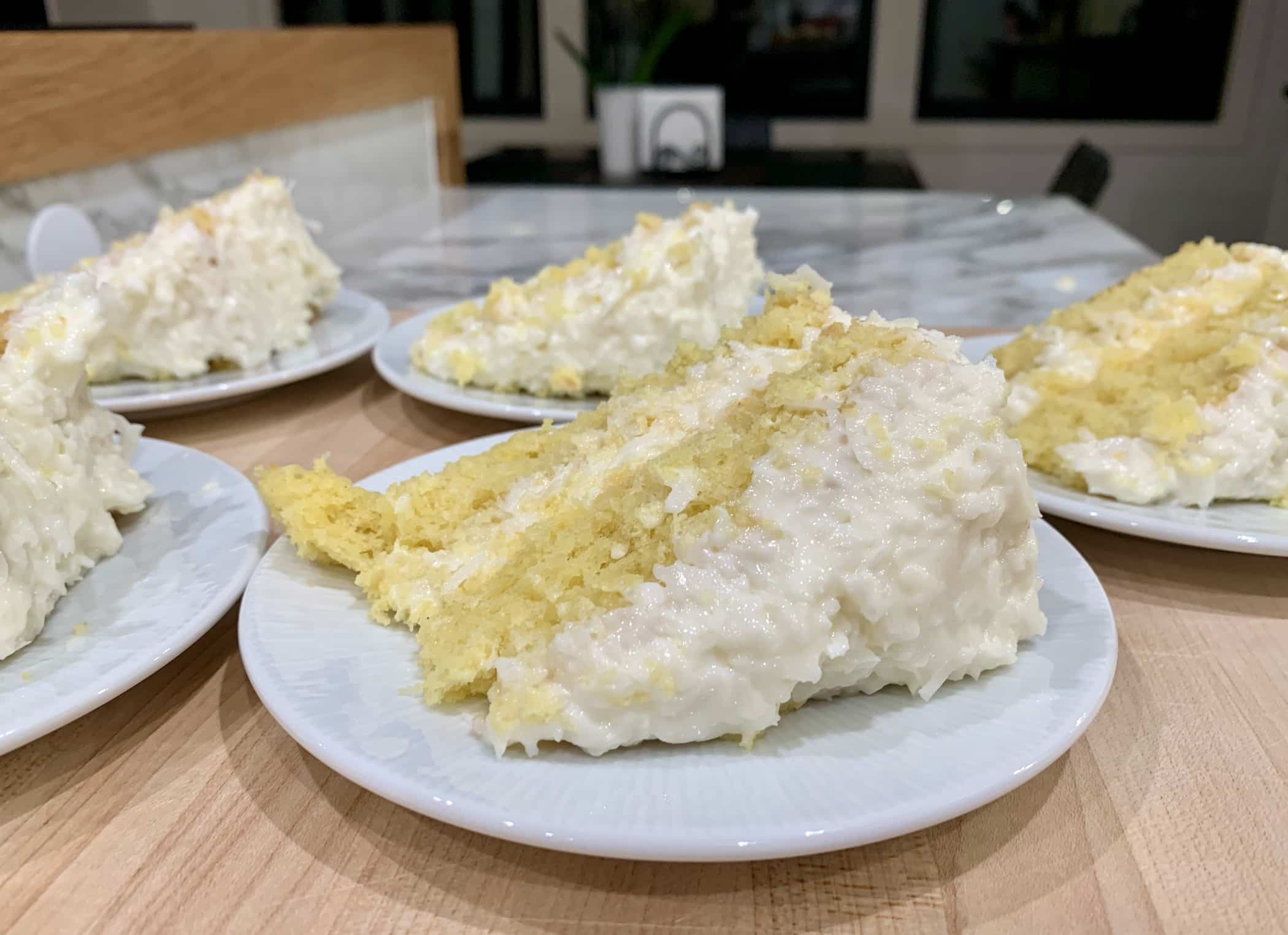 Delicious moist yellow cake covered with sweetened coconut sour cream frosting.
