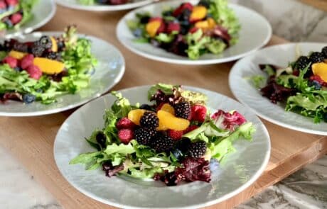 Mesclun salad greens tossed with red wine vinaigrette and topped with fresh fruit and berries.