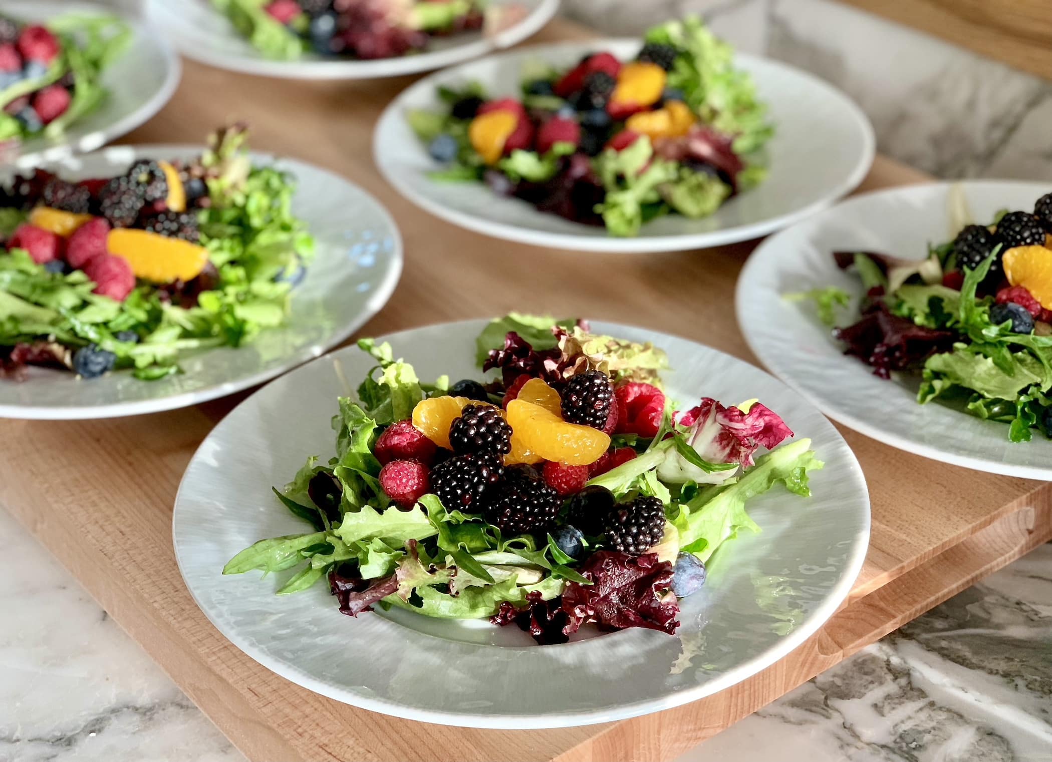 Mesclun salad greens tossed with red wine vinaigrette and topped with fresh fruit and berries.